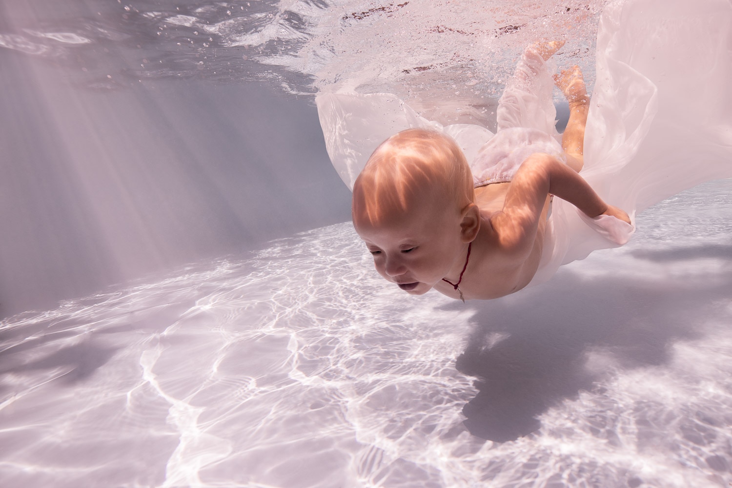 underwater baby photo session in a pool in bali